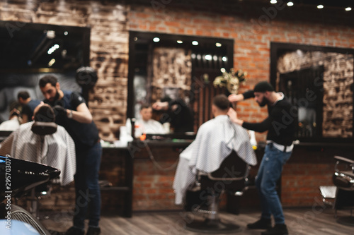 Haircut head in barbershop. Barber cuts the hair on the head of the client. The process of creating hairstyles for men. Barber shop. Selective focus.