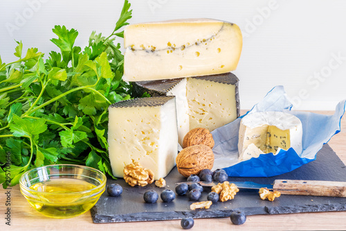 Asortment of cheese with fruit and nuts on the table. photo