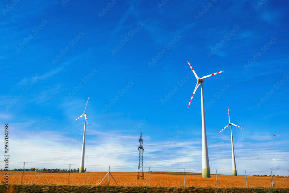 Green technology concept. Wind generators in field