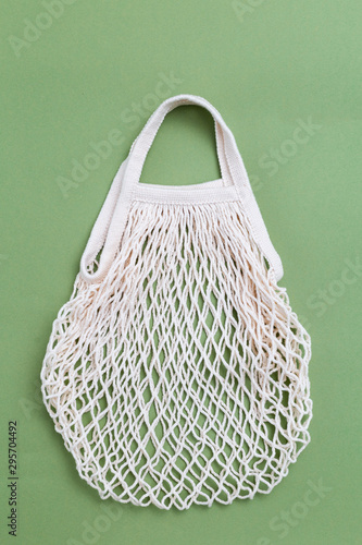 Reusable bag on green background. plastic‑free concept. Vertical photo