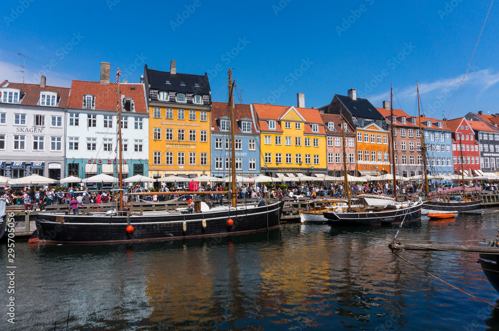 Summertime in the fantastic city of Copenhagen. Iconic Nyhavn with its colorful houses and old boats