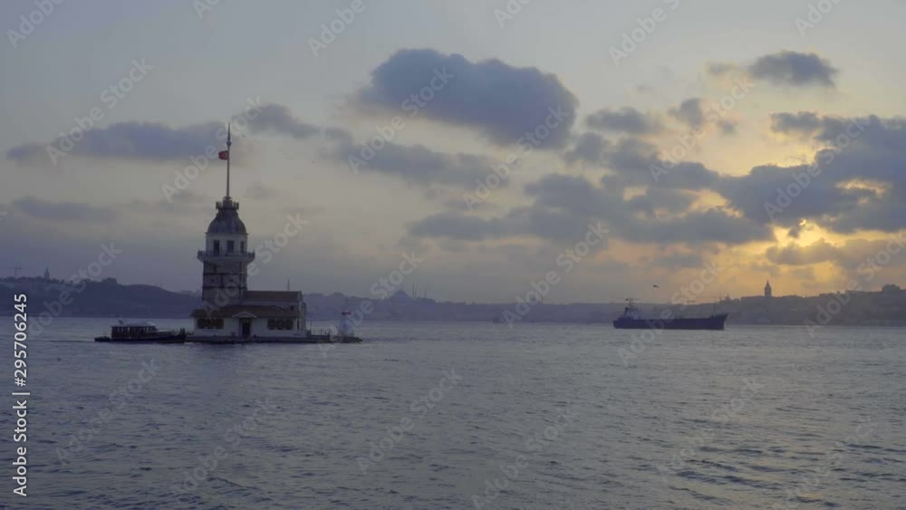 Kız Kulesi Maiden's tower standing in harbor of Uskudar with cargo ship traveling past in the distance Kız Kulesi Maiden's tower standing in harbor of Uskudar with cargo ship traveling past in the distance
