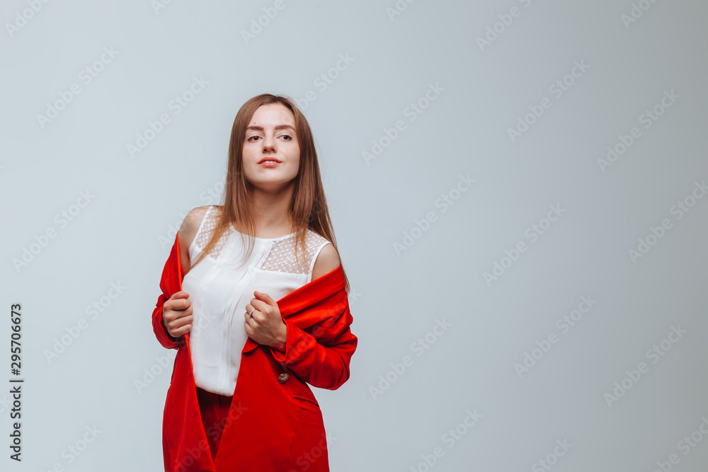 Girl in a red jacket on a light background Girl in a red jacket on a light background