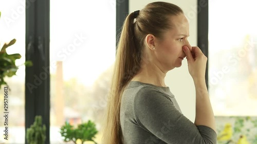 Woman reacts to stink. Bad smell. Stench. Mud.