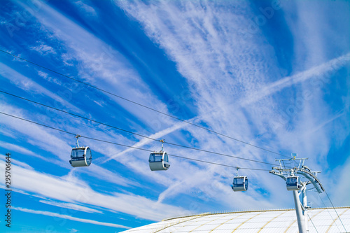 Cableway cabins on a background of blue sky with clouds