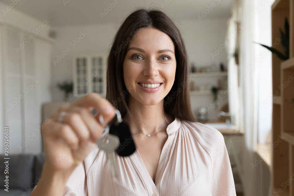 Head shot portrait smiling woman, satisfied customer holding keys Head shot portrait smiling woman, satisfied customer holding keys