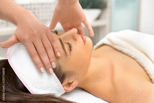 spa  resort  beauty and health concept - beautiful woman in spa salon getting face treatment