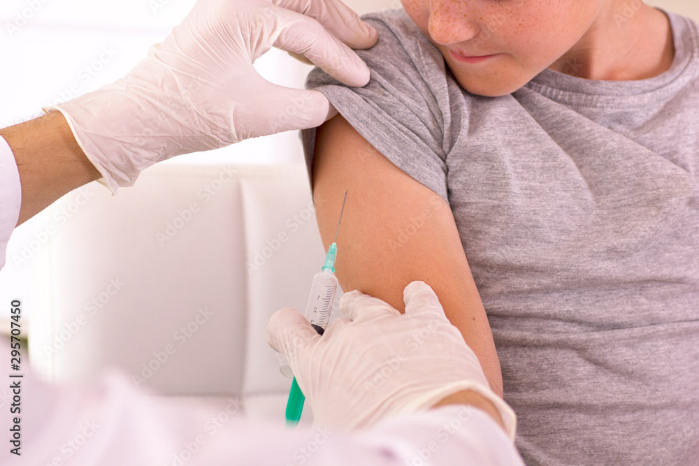 A child is given a vaccine against the virus A child is given a vaccine against the virus