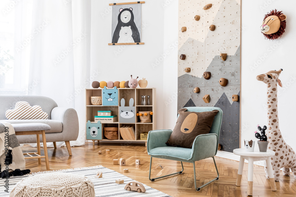 Stylish scandinavian interior design of childroom with gray sofa, modern  climbing wall for kids, design furnitures, soft toys, teddy bear and cute  children's accessories. Home decor. Template. Stock Photo | Adobe Stock