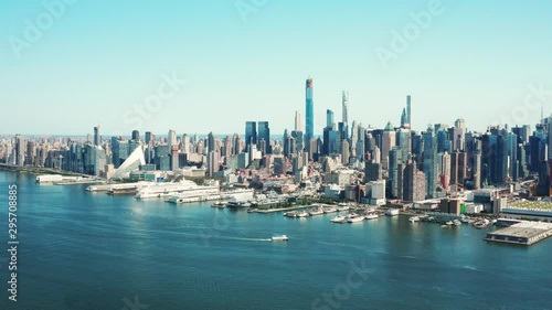 Aerial of Hudson Bay, high view of Manhattan cityscape, skyscrapers and landmark buildings, New York City at daytime, ships crossing cannel
