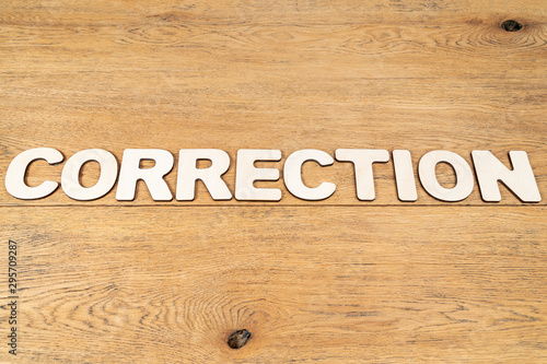Word correction on a wooden table