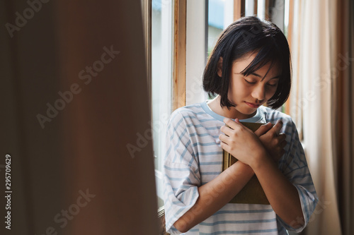 The girl hugged the holy scriptures