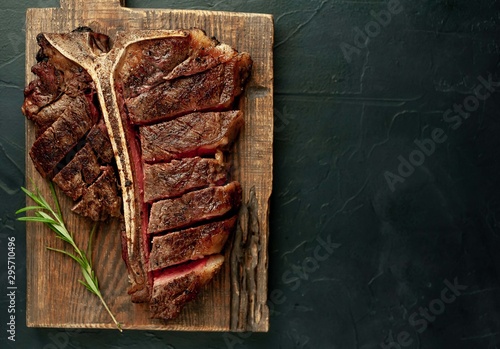  Grilled T-bone steak on a stone table. With copy space for your text.