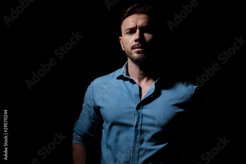 Canvas-taulu casual man standing in the shadows with arrogance