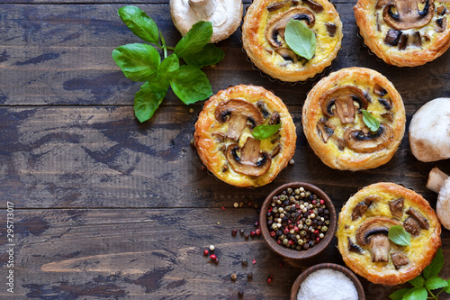 Tartlets with mushrooms and chicken on a wooden background. View from above.