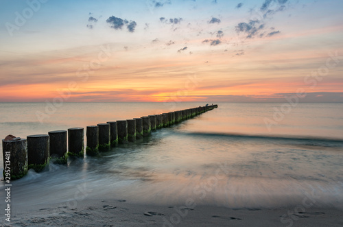 Fototapeta Naklejka Na Ścianę i Meble -  Baltic sea seascape at sunset, Poland, wooden breakwater and waves