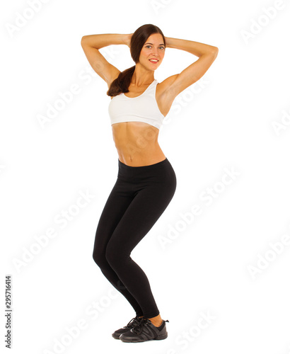 Young healthy girl doing exercises, full length portrait isolated over white background