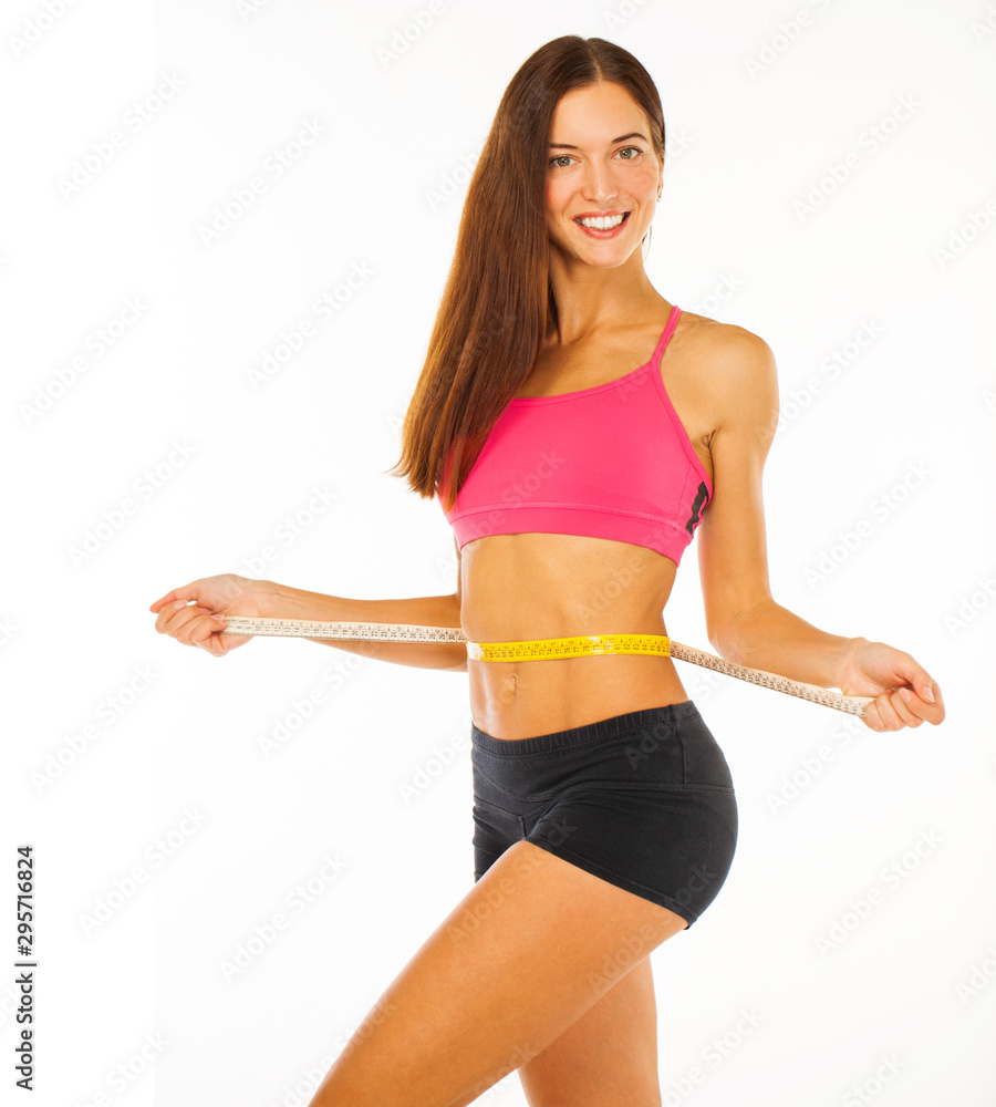 Fitness model with a flat stomach isolated on a white background Fitness model with a flat stomach isolated on a white background