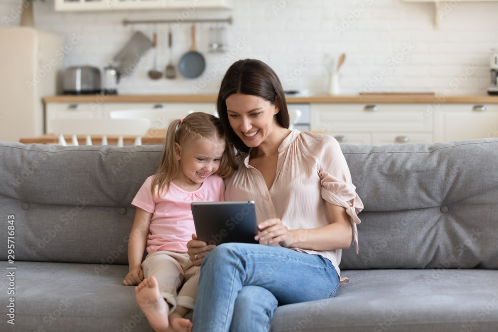 Happy mother and daughter using computer tablet, making video call Happy mother and daughter using computer tablet, making video call