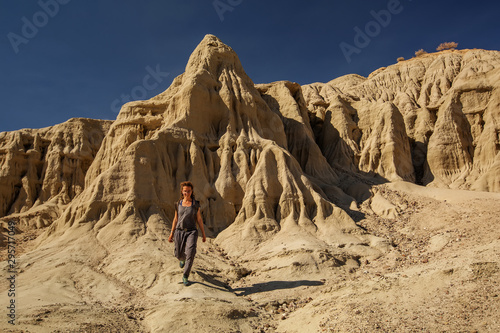 A hiker in the Artist`s Palette landmark place in Death Valley National Park, Geology, sand.