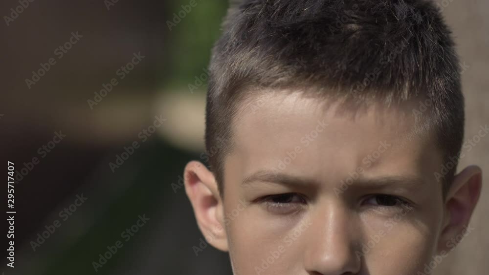 portrait of a serious caucasian boy outdoors close-up portrait of a serious caucasian boy outdoors close-up