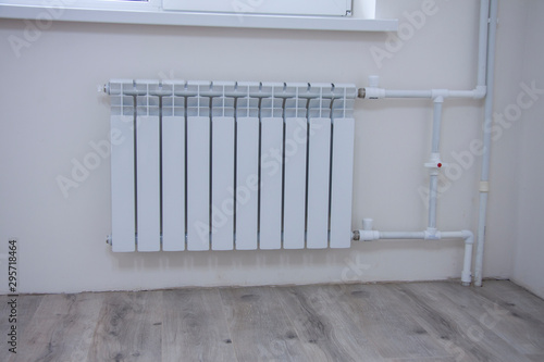 Wallpaper Mural Repair of the heating system in the room concept. Connecting a new white radiator in an empty room. Preparing the battery for the heating season. Torontodigital.ca