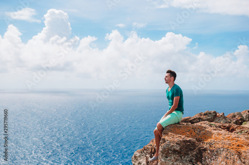 Young man enjoying breathtaking views of beautiful landscape