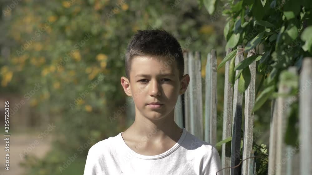 portrait of a serious caucasian boy outdoors close-up portrait of a serious caucasian boy outdoors close-up