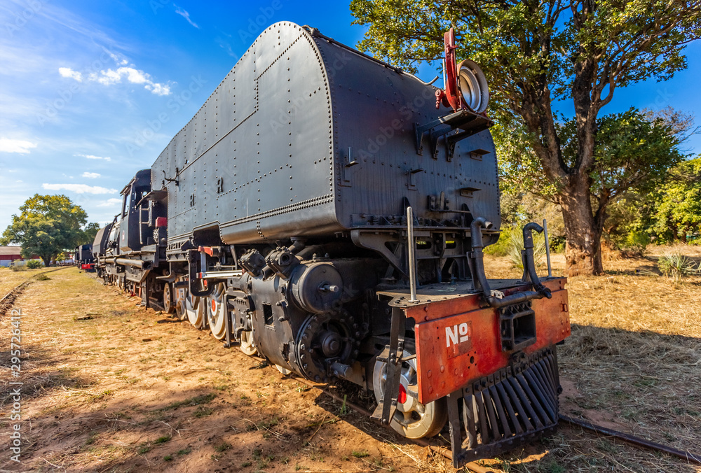 Old retro steel locomotive train standing on the rails in Livingstone, Zambia Old retro steel locomotive train standing on the rails in Livingstone, Zambia