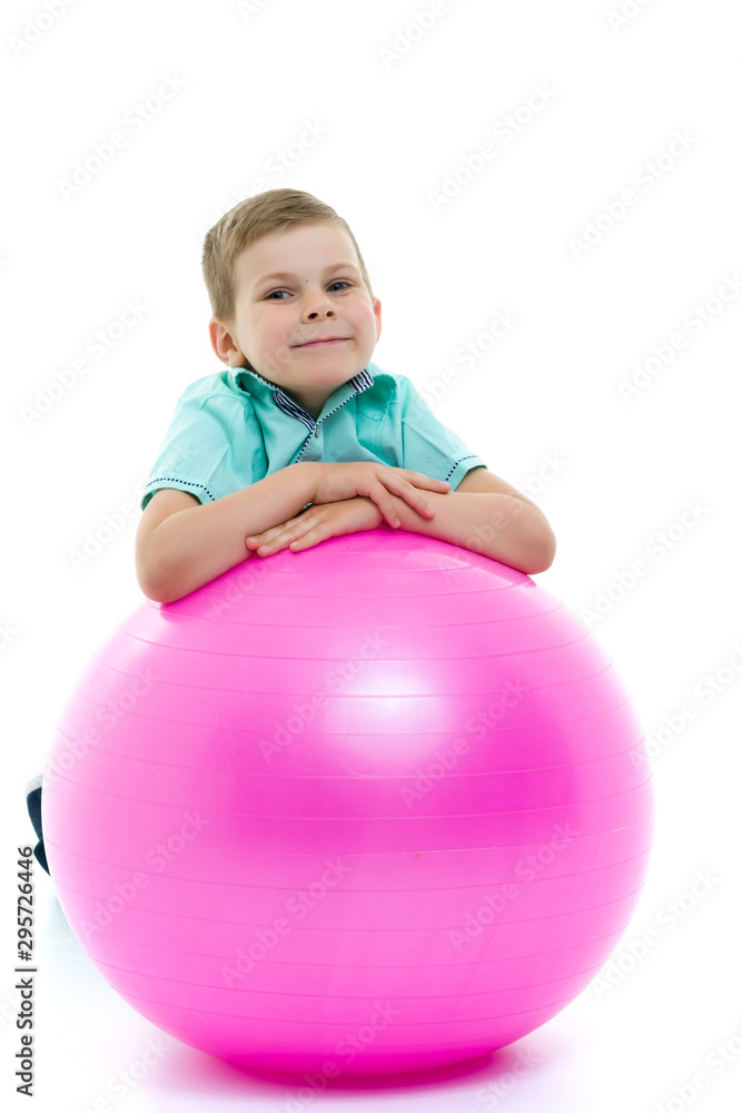 Cute boy playing with fit ball isolated on white Cute boy playing with fit ball isolated on white