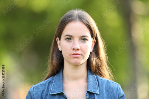 Serious woman looking at camera in a park