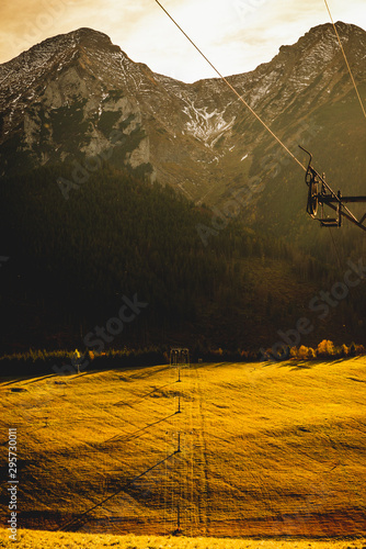 High rocky mountains against the background of the setting sun. Zdiar in Slovakia, high Bielanske Tatras. Trip to the mountains, climbing, hiking in the mountains. Tourists in the mountains. photo