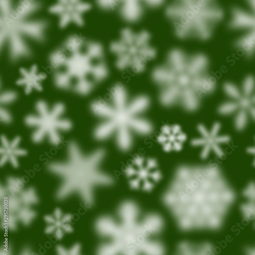 Christmas seamless pattern of white defocused snowflakes on green background