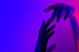 Hands in colorful blue red contrast neon light