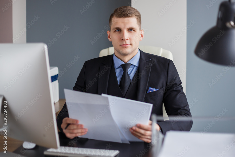 Businessman reading contract in office Businessman reading contract in office