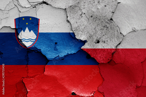 flags of Slovenia and Poland painted on cracked wall