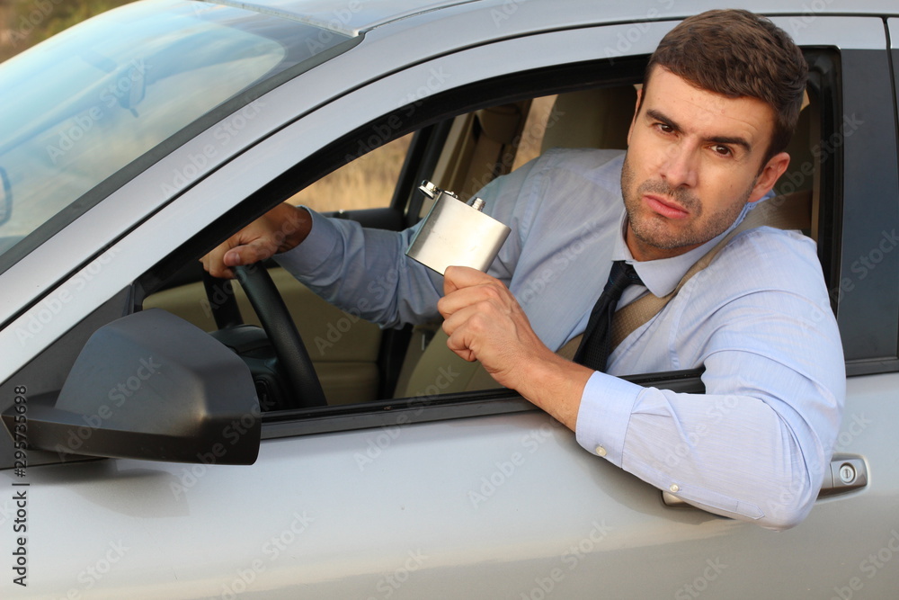 Businessman drinking alcohol while driving 