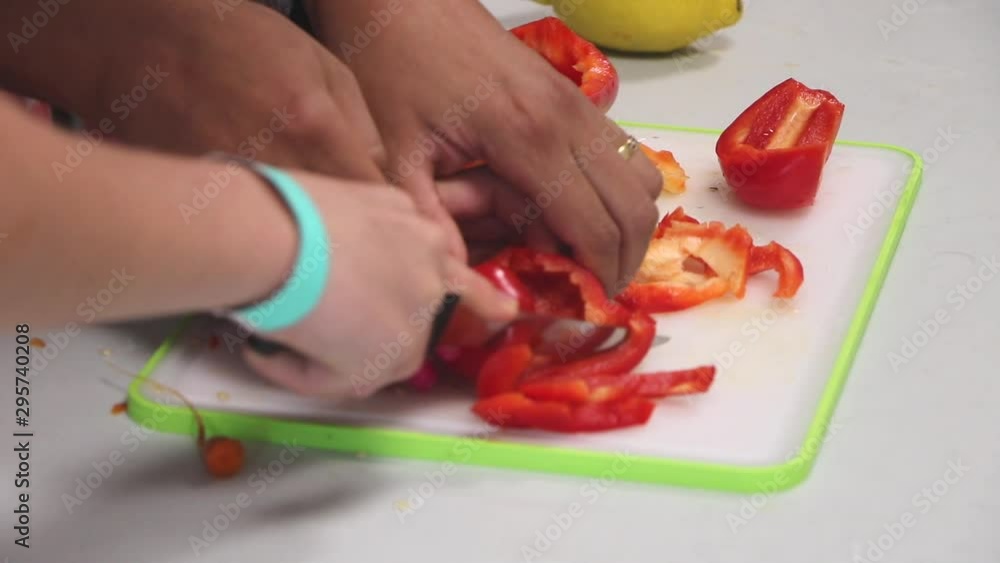 Chopped red pepper in a white kitchen. Ingredient for hot spicy chili. Closeup on woman's hands. Healthy, organic, vegetarian, vegan food. Traditional homemade dish. Cook scene with raw vegetables. Chopped red pepper in a white kitchen. Ingredient for hot spicy chili. Closeup on woman's hands. Healthy, organic, vegetarian, vegan food. Traditional homemade dish. Cook scene with raw vegetables.