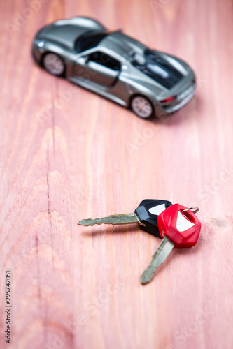 Car Loands and Credit Concepts. Car Symbol Along With bunch of Keys Against Vintage Wooden Background.