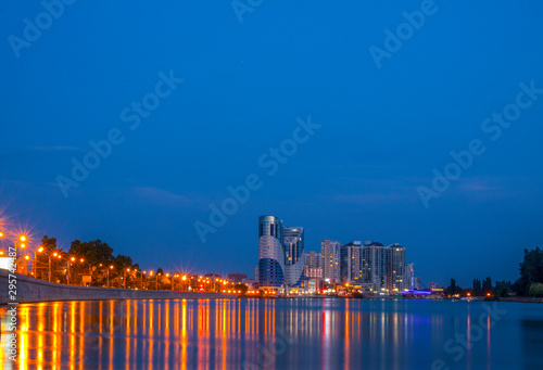 Russia. Krasnodar. River Kuban. Buildings are reflected in the river. Lights on the waterfront