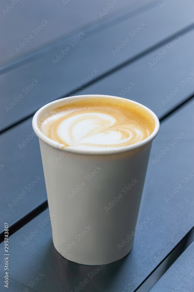 The cup of coffee on the wooden table The cup of coffee on the wooden table