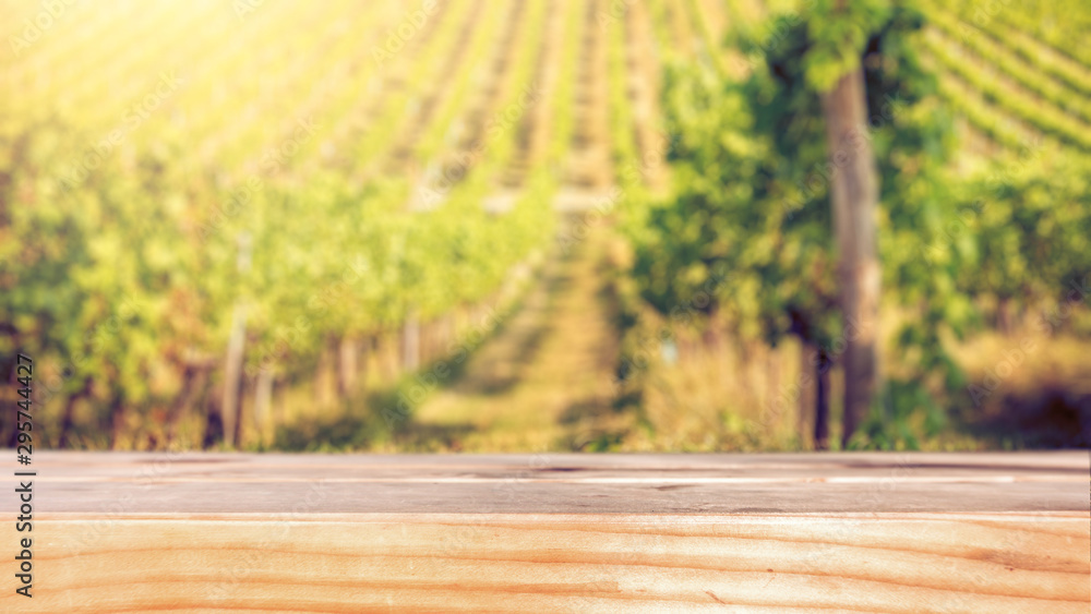 Wooden flat Tabletop against vineyard hill in late summer Wooden flat Tabletop against vineyard hill in late summer