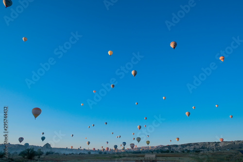 Many hot air balloons flying in Goreme, Cappadocia