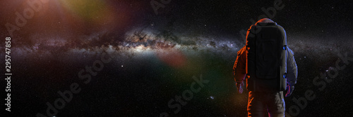 standing astronaut in front of the beautiful Milky Way galaxy