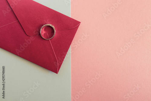 Flat lay of rdl envelope with ring beautiful paper background. Simple and minimal frame photo