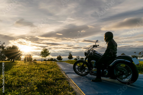 biker on the road on sunset
