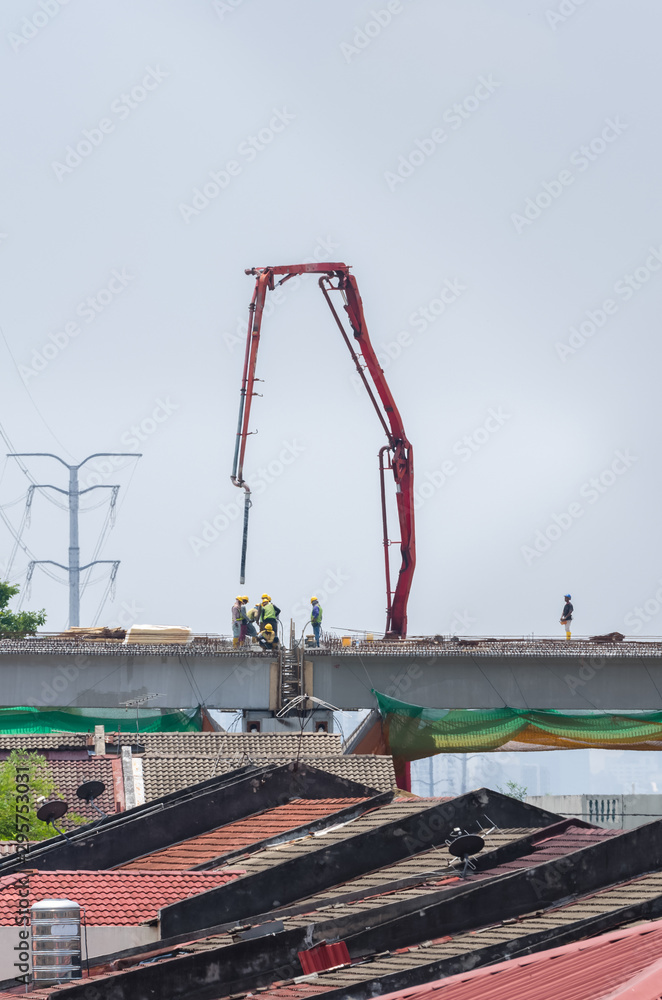 Scene view of the workers working on the construction of a highway bridge. Scene view of the workers working on the construction of a highway bridge.