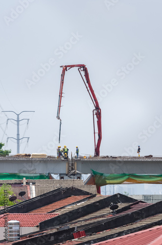 Scene view of the workers working on the construction of a highway bridge.