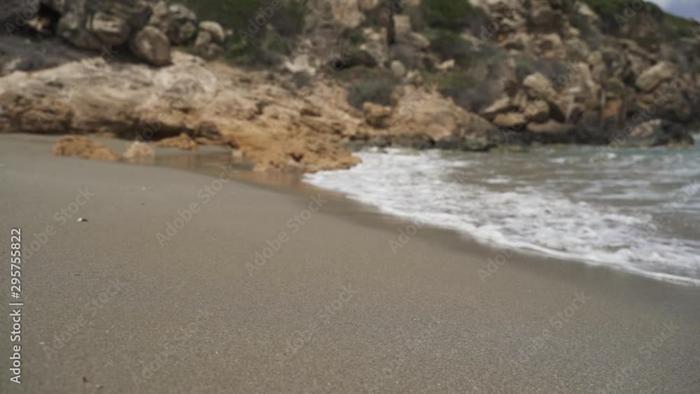 Waves splashing on seashore by rock in slow motion Waves splashing on seashore by rock in slow motion