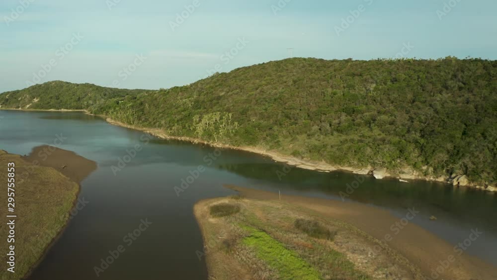 Aerial flying forward river stream, river island surrounded by green hills Aerial flying forward river stream, river island surrounded by green hills
